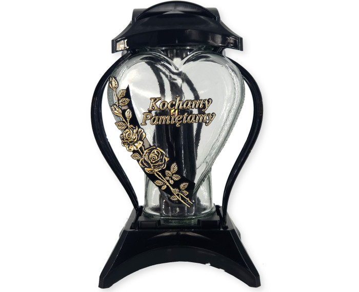 Duży znicz z napisem "Kochamy Pamiętamy" i ozdobnym kwiatem